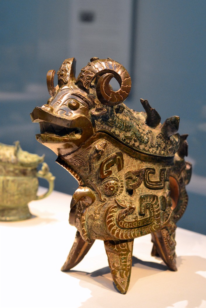 Lidded ritual ewer (guang) with taotie, dragons, birds, tigers, elephants, fish, snakes, and humans From 1100 - 1050 BCE Lidded ritual ewer (guang) with taotie, dragons, birds, tigers, elephants, fish, snakes, and humans From 1100 - 1050 BCE